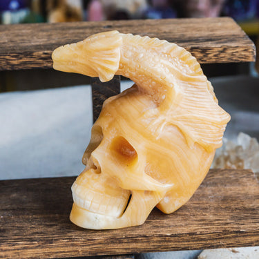 Orange Calcite Skull With Flying Dragon